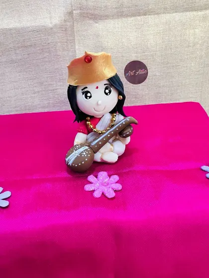 A handmade miniature of Goddess Saraswati, created to celebrate Vasant Panchami. These clay dolls are a beautiful way to honor our traditions.