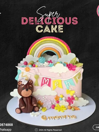 A beautiful cake celebrating nine months, halfway to one! This design features a rainbow, a cute teddy bear, and colorful flowers, personalized with the baby's name on a sweet banner.