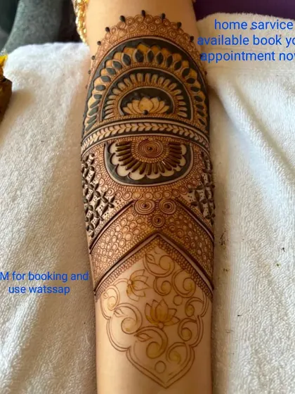 A beautiful cuff-style design on the forearm, featuring a large lotus mandala. This is a great option for someone who wants a detailed but not full-arm design.