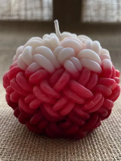 A unique, hand-poured knot-ball candle. These are available in various colors and fragrances like rose, lavender, and lemongrass.