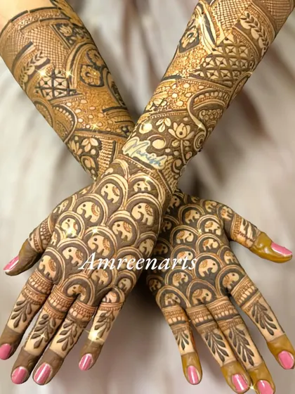The back of the hands, covered in a playful pattern of repeating baby elephants.