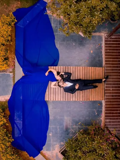 Another stunning aerial view of a couple, showcasing the beautiful contrast between the blue gown and the natural surroundings. Drone photography allows for these truly unique compositions.
