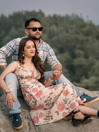 A relaxed moment on a rock overlooking the hills. This captures the peaceful, comfortable side of being together in nature.
