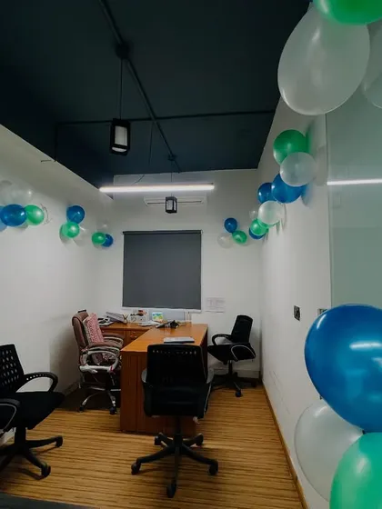 Even formal spaces like meeting rooms can be decorated for a celebration. Here, I have placed simple balloon clusters to add a festive touch.