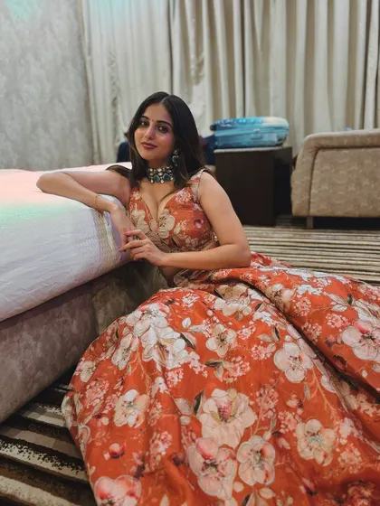 A serene portrait of the client in her floral lehenga.