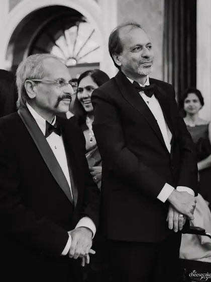 The proud fathers watching the celebrations, their expressions full of happiness.