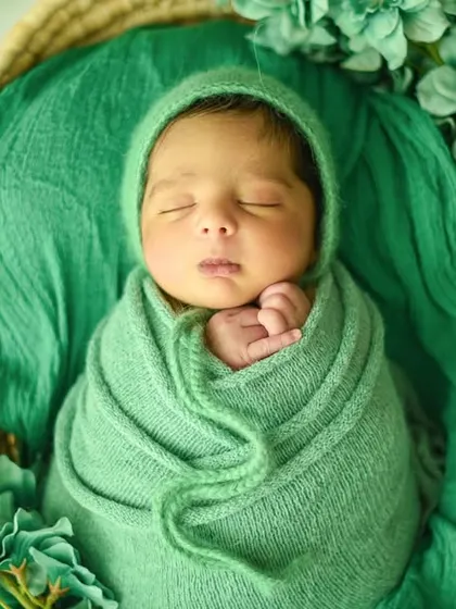 Another variation of the green theme, this time with the baby's hand peeking out, adding a touch of personality to the pose.