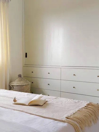 Designing custom wardrobes is one of my favorite parts of a project. For this master bedroom, I created a wall of built-in closets with classic shaker-style doors and simple brass knobs, providing a clean look with plenty of storage.