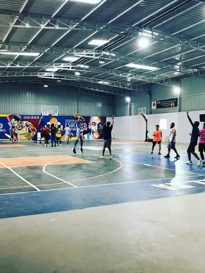 Players celebrating a basket during a lively game. The energy and community are what make playing at our facility special.