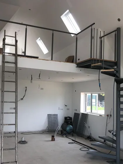 The raw steel structure in place. This is the first major step of the on-site installation process for a bespoke spiral staircase.