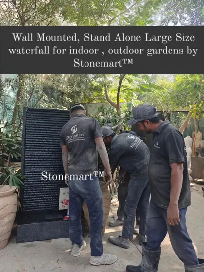 My team is shown moving the large, wall-mounted granite waterfall. This piece is heavy and built to last for generations.