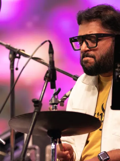 Our drummer, fully engaged in the rhythm at the Bengaluru Ganesh Utsava. His powerful playing drives the high-energy sections of our fusion concerts.