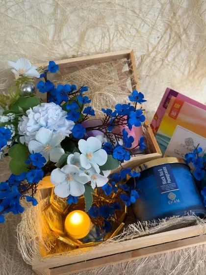 A slightly different angle of the blue themed EKAM collaboration hamper, showing the warm glow of the tea light.