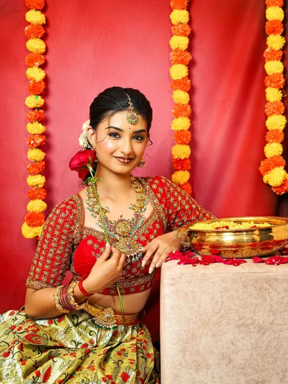 A happy and radiant shot of the model, giving a clearer view of the layered antique necklaces and matching nose ring.