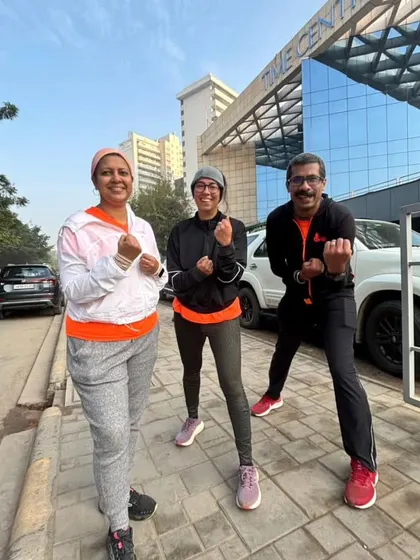 Three of our runners posing in front of our favorite post-run spot. Community is built in these moments.