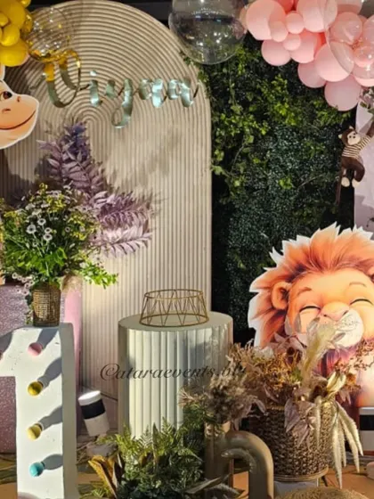 Detail shot of the "Wild One" decor, featuring a light-up number, a sleepy lion prop, and a green wall accent.