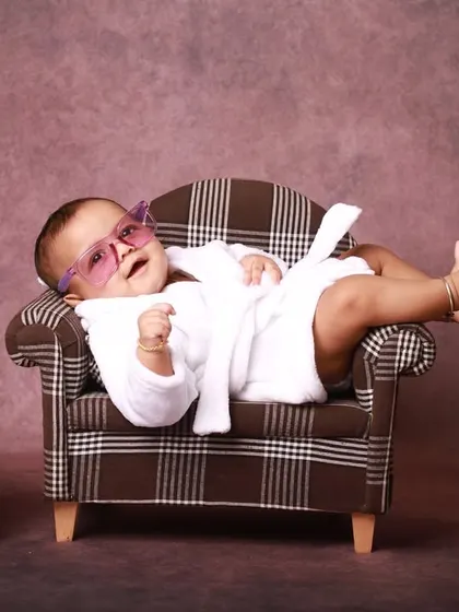Kicking back and relaxing. This shot captures the pure confidence and charm of a six-month-old, perfectly at ease in the miniature lounge setup I created for this milestone session.