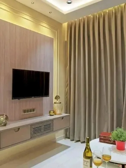 A simple and elegant floating TV unit. This minimalist design is perfect for smaller living rooms, providing storage without feeling bulky.