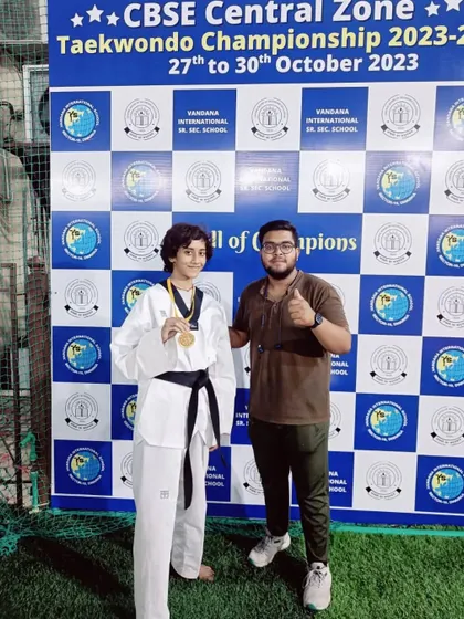 Roshni Tank proudly displays her gold medal from the CBSE Central Zone Championship. Her victory in the U-49kg category was a highlight for our team.
