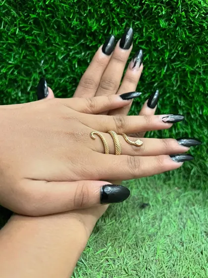 This manicure is all about sharp, dramatic style. The extra-long stiletto nails are painted in a glossy, opaque black for a fierce and confident statement.
