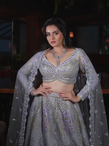A powerful pose from Tanvi Negi's reception look shoot. The makeup, with its purple smokey eye and flawless base, is designed to be bold and memorable.