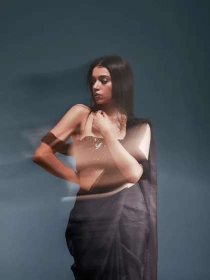 Another take on the motion blur effect, this shot captures a different angle and pose. The technique highlights the model's form while creating an artistic and abstract visual.