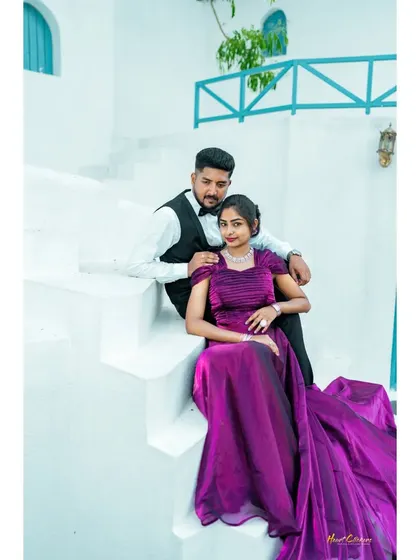 Elegance and romance captured on the steps of a beautiful white villa. The bride's flowing purple gown drapes gracefully, creating a sophisticated and timeless pre-wedding portrait.