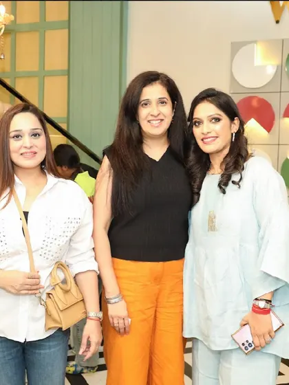 Friends enjoying the party and posing for a picture near our iconic logo wall.