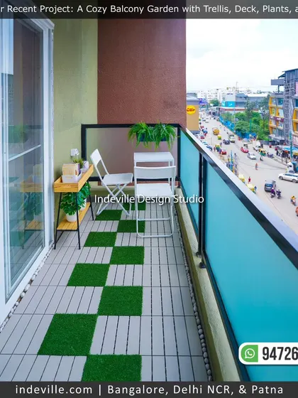 A cozy balcony garden overlooking a busy street. I used checkerboard-patterned deck and grass tiles, a simple white cafe-style table and chairs, and a small plant stand to create a functional and green urban viewpoint.