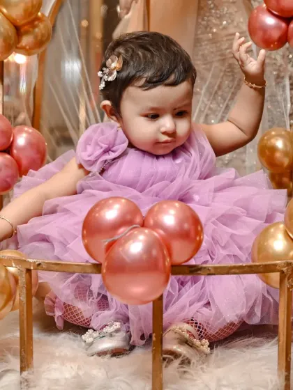 Capturing a sweet, candid moment as the birthday girl reaches for the balloons. My goal is to document the natural expressions and actions that define a child's personality.