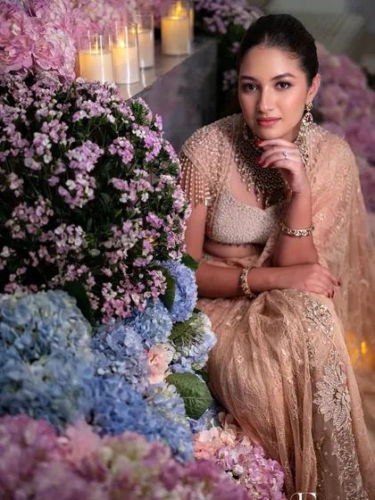 An artistic shot of the client amidst a sea of flowers, looking ethereal and elegant.