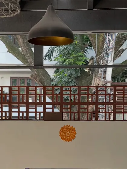 A detail of the studio's decor, with a modern pendant lamp and a traditional mandala motif on the wall. It reflects our blend of contemporary design and heritage craft.