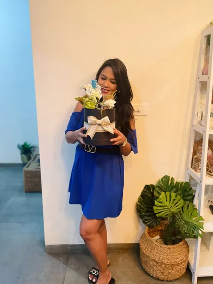 A happy client and our founder, holding a beautifully curated hamper. Seeing the joy our gifts bring is the best part of our job.