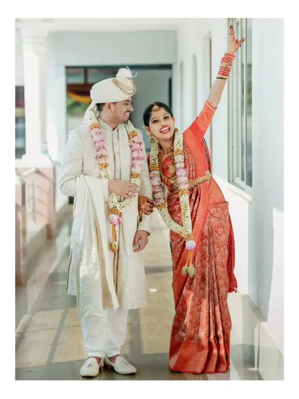 A fun and energetic shot of a newly married couple, with the bride cheering joyfully.