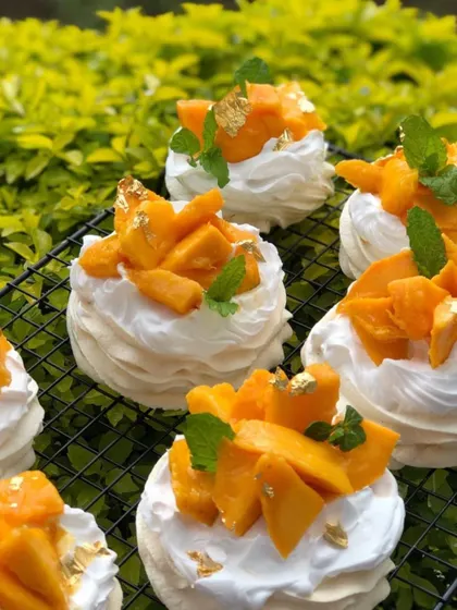 A tray of individual mango pavlovas, ready for a party.