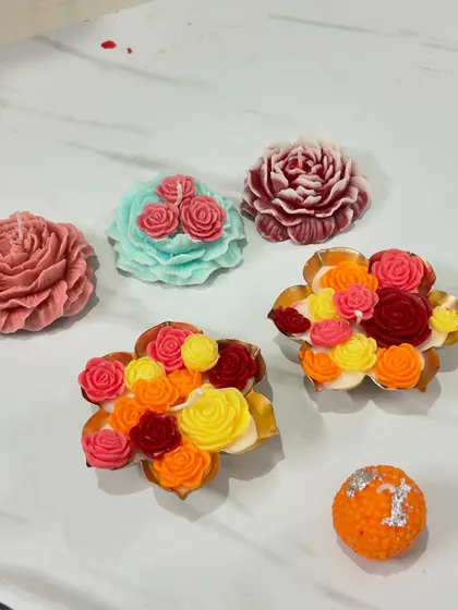 An assortment of colorful, detailed flower-shaped candles.