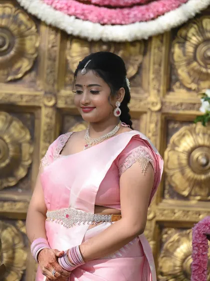This image highlights the details of the look, from the neat hairstyle to the perfectly draped saree and subtle makeup.