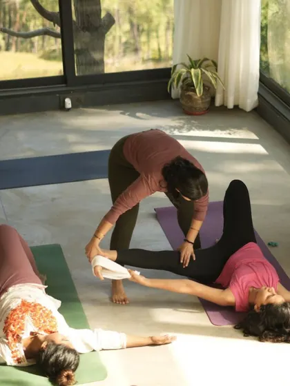 In my classes, I provide gentle, hands-on assists to help you understand the alignment of a pose. Here, I'm helping a student find more space in Supta Padangusthasana.