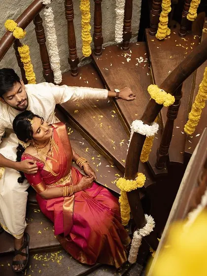An overhead view of a quiet moment on a spiral staircase, adorned with wedding flowers. I look for unique perspectives to tell your story in a more artistic and memorable way.