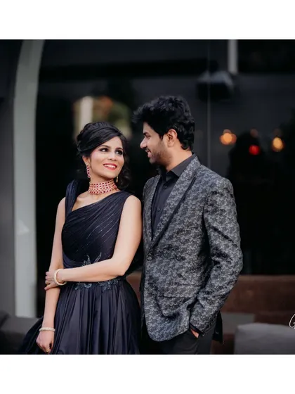 A chic couple portrait. The bride's glamorous makeup, featuring a dark smokey eye, stands out beautifully against her elegant evening gown.