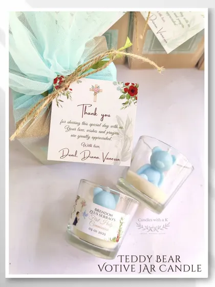 A close-up of a teddy bear votive jar candle, a popular choice for First Holy Communion return gifts, shown here with its custom packaging.
