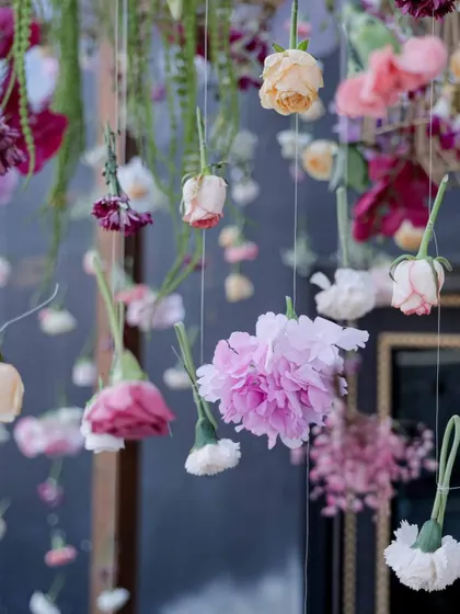 Delicate hanging flowers create a floral curtain, adding a whimsical and romantic touch to the 'Victorian Bageecha' theme.