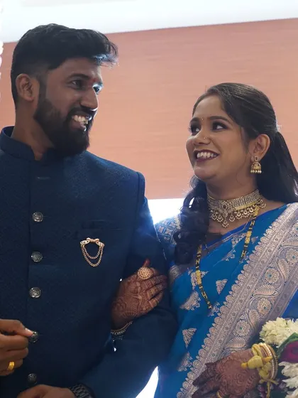 A loving glance between the couple. The bride's reception makeup is soft and romantic, perfect for capturing these sweet memories.