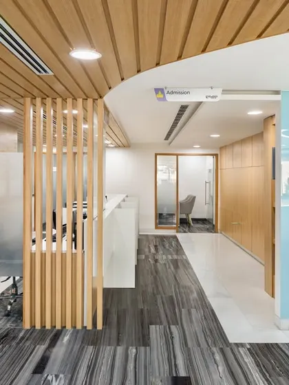 Our design for Fortis Ludhiana reimagines the healthcare experience through a material palette that blends warmth with clinical precision. The reception and waiting area use wood veneers and comfortable seating to soften the clinical environment.