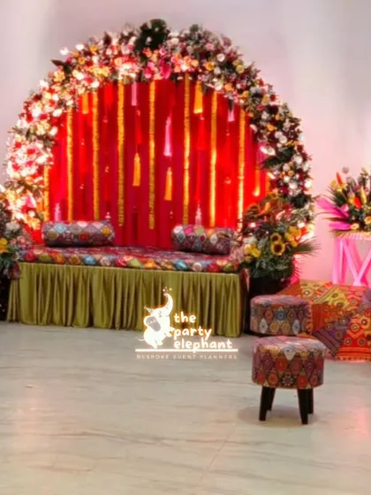 A wide view of the colorful Mehendi setup, showing the main seating area, guest seating, and additional decor elements that filled the space with vibrant energy.