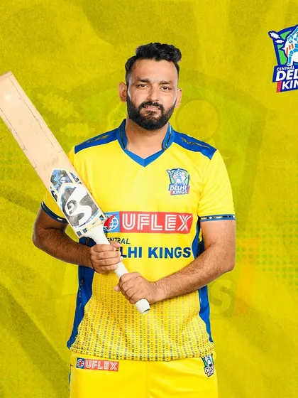 Posing with my bat in the official Delhi Kings kit. The tools of the trade are just as important as the technique.
