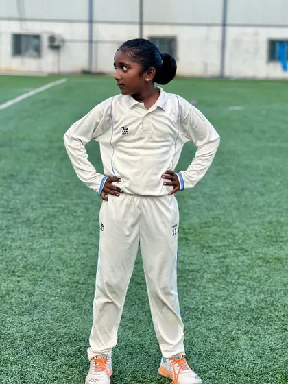 Confidence on the field. One of our promising young female cricketers strikes a pose, embodying the spirit of our girls' program.