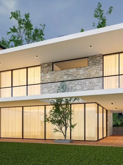 The rear view of the Malsi Forest residence, showcasing a cantilevered upper floor that creates a sheltered outdoor living area. The design emphasizes indoor-outdoor living with expansive glass walls that open onto the lawn.