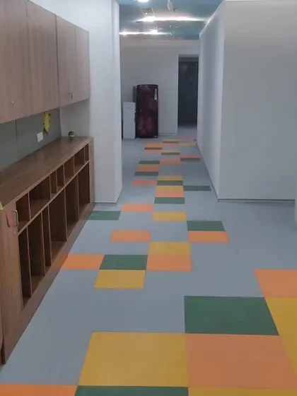 Colorful vinyl flooring installed in a hallway. This material is strong, water resistant, and ideal for schools, hospitals, or commercial areas that need to be cleaned often.