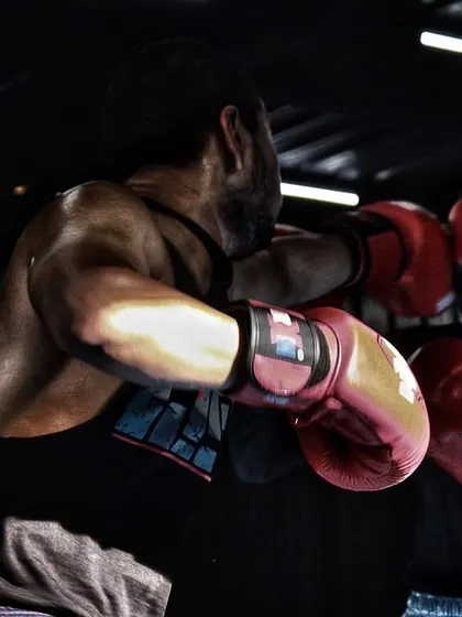 A female fighter sparring with a male partner, working on her defense against a stronger opponent. Our gym is for everyone who is serious about the sport, man or woman.